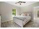 Bright bedroom with light wood platform bed and ceiling fan at 7930 Blackwood Rd, Denver, NC 28037