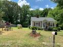Landscaped yard with a charming cottage and manicured lawn at 507 North Dr, Cherryville, NC 28021