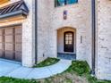 Elegant front entry with arched doorway and brick facade at 405 Audrey Pl # 02, Charlotte, NC 28226