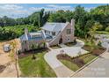Luxury home with brick exterior, large driveway, and landscaped yard at 8010 Litaker Manor Ct, Charlotte, NC 28270