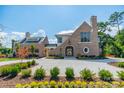 Brick front exterior of a two-story home with landscaping and a large driveway at 8010 Litaker Manor Ct, Charlotte, NC 28270