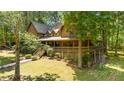 Log home with large yard and detached garage, view from driveway at 6255 Meadow Ln, Salisbury, NC 28147