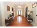 Elegant entry hall with hardwood floors, antique furniture, and a charming front door at 318 Camden Rd, Wadesboro, NC 28170