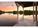 Serene lake view from a wooden dock at sunset at 192 Diana Dr, Mount Gilead, NC 27306