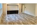 Living room with wood-look floors and built-in shelving at 5756 Dalmatian St, Iron Station, NC 28080