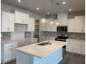 Modern kitchen with white cabinets, quartz countertops, and an island at 5645 De Vere Dr # 103 Blayre, Indian Land, SC 29707