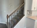 Wood staircase with wrought iron balusters leading to the second floor at 5645 De Vere Dr # 103 Blayre, Indian Land, SC 29707