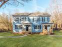 Two-story duplex with light blue siding, wooden porches, and landscaped lawns at 2885 Vale Ave, Kannapolis, NC 28081