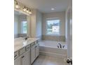 Elegant bathroom with double vanity, soaking tub, and tiled floor at 1503 Laggan Ln # 58- Gaines Td, Indian Trail, NC 28079