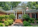 Brick home with a classic portico, landscaping, and a welcoming front entrance at 620 N 9Th St # 5/6, Albemarle, NC 28001