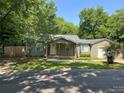 Ranch home with green exterior, garage, and yard at 620 Central Ave, Albemarle, NC 28001