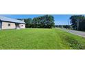 Small house with a large grassy yard, located on a road with trees at 1672 Riverview Rd, Lincolnton, NC 28092