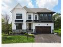 Two-story farmhouse with white siding and stone accents at 11330 James Coy Rd # Covington, Davidson, NC 28036