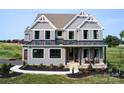 Two-story farmhouse with gray siding, black metal roof, and a front porch at 11330 James Coy Rd # Covington, Davidson, NC 28036