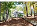 House nestled in woods with fall foliage at 3645 Lake Bluff Dr, Sherrills Ford, NC 28763