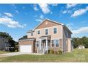 Two-story house with stone and vinyl siding, a white garage door and landscaping at 1030 Heath Helms Rd, Monroe, NC 28110