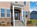 Stylish front door with stone and vinyl siding exterior at 1030 Heath Helms Rd, Monroe, NC 28110