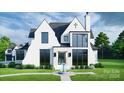 Elegant two-story home with white brick exterior, black roof, and a fountain at 8014 Litaker Manor Ct, Charlotte, NC 28270