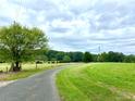Long driveway leading to property through a grassy field at 44333 Stony Gap Rd, Albemarle, NC 28001
