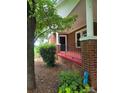 Brick house exterior with a red porch and black railing at 4210 Old Beatty Ford Rd, China Grove, NC 28023