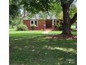 Brick ranch house with covered porch and large tree at 4210 Old Beatty Ford Rd, China Grove, NC 28023