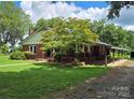 Brick ranch house with covered porch and carport at 4210 Old Beatty Ford Rd, China Grove, NC 28023