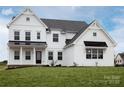 White farmhouse style home with a black metal roof at Lot 320 Waterton Trl # Hawthorne, Belmont, NC 28012