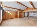Large living area with wood paneled walls and carpeted floor at 3616 County Home Rd, Conover, NC 28613