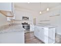 Bright kitchen with white cabinets, granite countertops and island at 105 Megby Trl, Statesville, NC 28677