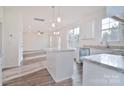 Open kitchen with island, stainless steel appliances, and hardwood floors at 105 Megby Trl, Statesville, NC 28677