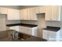 Modern kitchen with white cabinets and dark countertops at 2773 Ruby Mill Dr # 41, Gastonia, NC 28056