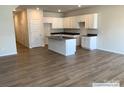 Modern kitchen with island, white cabinets, and dark countertops at 2773 Ruby Mill Dr # 41, Gastonia, NC 28056