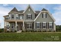 Two-story house with gray shake siding, stone accents, and dark shutters at 843 Lake Forest Dr # Devonshire, Belmont, NC 28012
