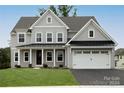 Two-story house with gray siding, white trim, and a black metal roof at 843 Lake Forest Dr # Devonshire, Belmont, NC 28012