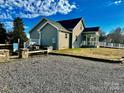 Gravel driveway and patio area with fire pit and seating at 709 Mocksville Hwy, Statesville, NC 28625