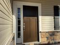 Brown front door with sidelights and stone accents at 121 High Rock Ct # 08, Statesville, NC 28677