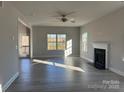 Bright living room with hardwood floors, fireplace, and access to a deck at 117 High Rock Ct # 09, Statesville, NC 28677