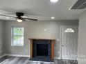 Living room featuring a modern fireplace and gray vinyl plank flooring at 108 Lee Dr, Shelby, NC 28150