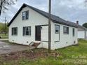 White brick ranch house with dark brown window frames, showcasing a side view at 108 Lee Dr, Shelby, NC 28150