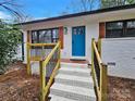 Front view of renovated ranch with blue door and steps at 533 Amon Ln, Pineville, NC 28134