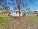 Back view of a renovated ranch house with landscaping at 533 Amon Ln, Pineville, NC 28134