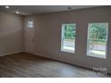 Bright living room with hardwood floors and large windows at 4227 S New Hope Rd # 10, Cramerton, NC 28032