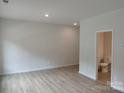 Spacious bedroom with vinyl flooring and attached bathroom at 4227 S New Hope Rd # 10, Cramerton, NC 28032