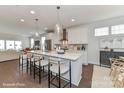 Modern kitchen with island, white cabinets, and quartz countertops at 122 Wesser St # 14, Davidson, NC 28036