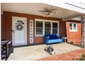 Inviting front porch with a blue bench, wicker chairs, and a welcome sign at 8300 Mount Holly Rd, Charlotte, NC 28214