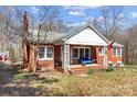 Brick ranch house with a covered porch and a spacious front yard at 8300 Mount Holly Rd, Charlotte, NC 28214