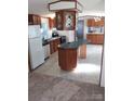 Kitchen with green island and wood cabinets at 215 Four Lakes Dr, Cleveland, NC 27013