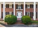 Classic front entrance with columns and a white door at 615 Peach St, Shelby, NC 28150