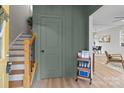 Entryway with stairs, green walls, and a wooden cart at 310 New Bern Ave, Statesville, NC 28677