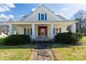 Farmhouse with a front porch and well-maintained lawn at 206 E Allenton St, Mount Gilead, NC 27306